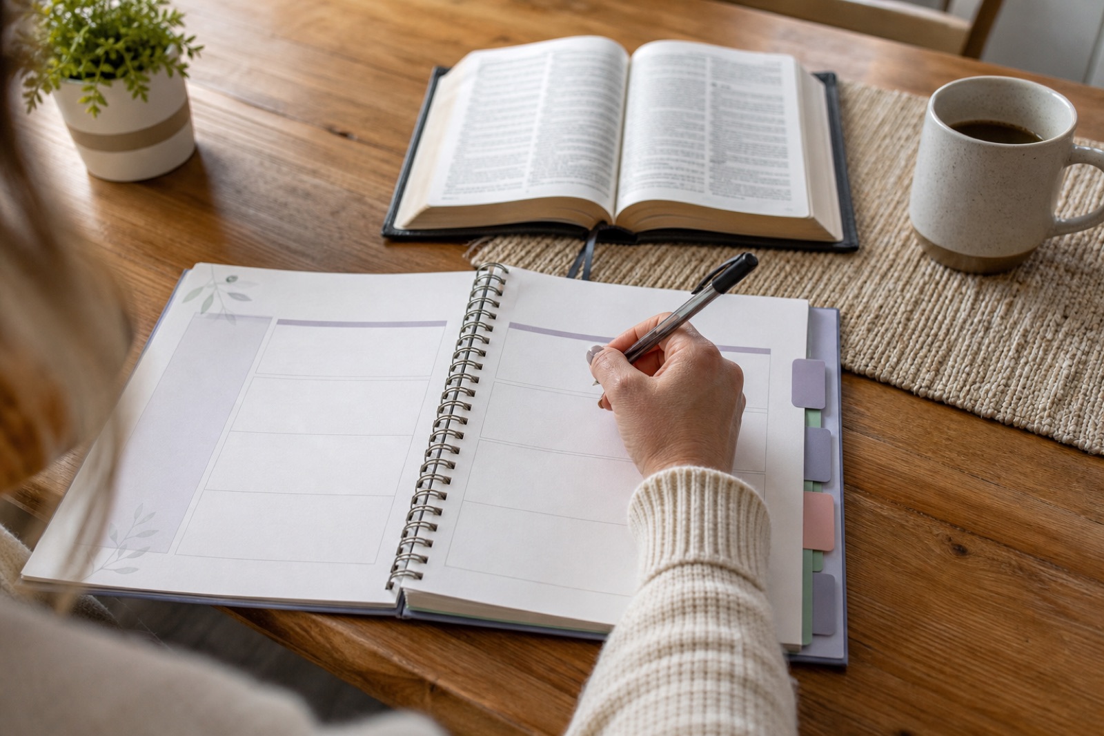 A woman filling in a family devotional planning page beside an open Bible.
